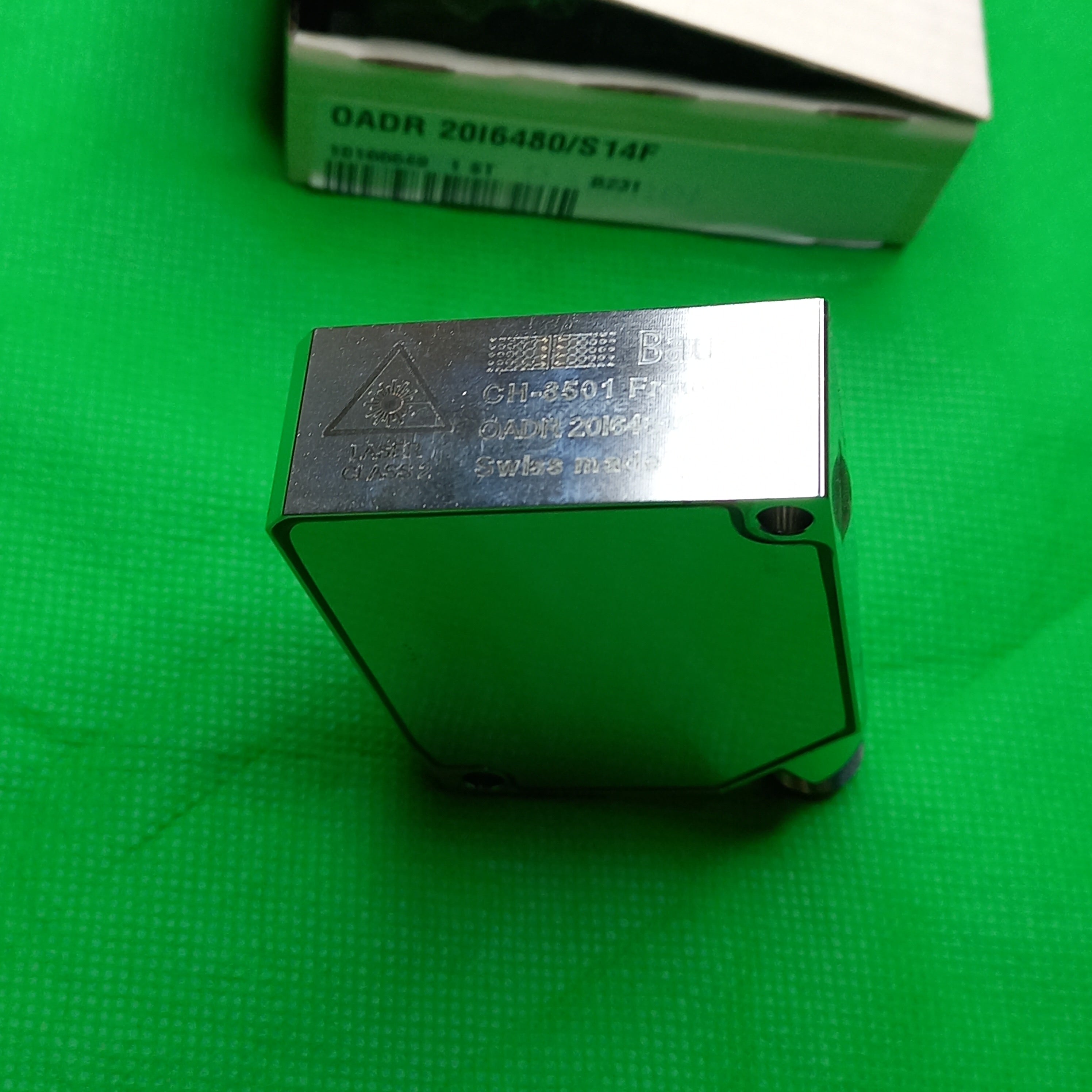 PHoto of Baumer Distance sensor by the side of original box Baumer Distance sensor 0ADR20 (Laser, variable sensing range) OADR 20i6480/S14F