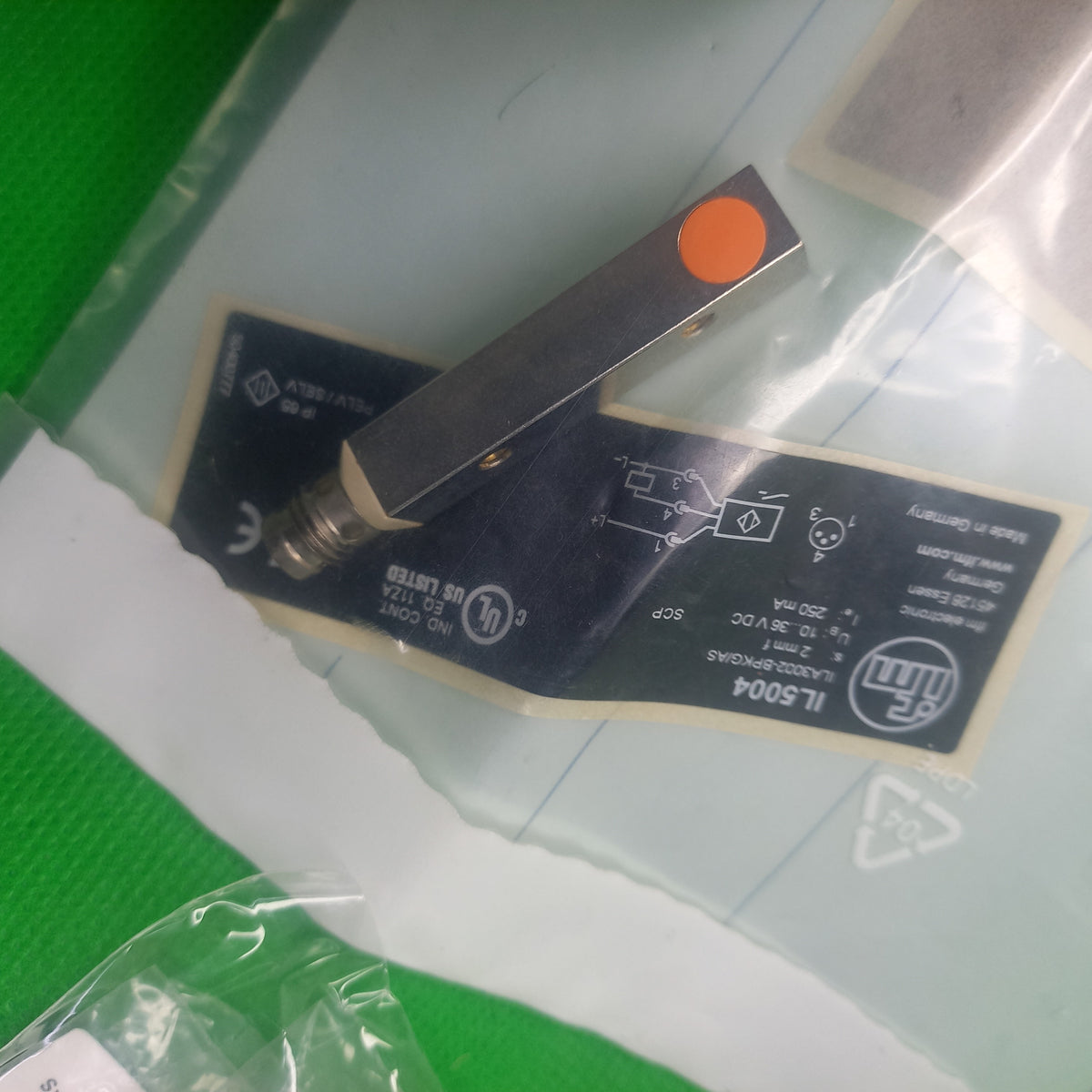 Inside the pouch packaging IL5004 sensor made by IFM , Rectangular sensor 2mm range, flush mounting PNP NO. M8 connector  3pin