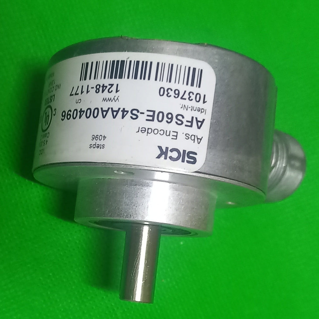 A SICK abs encoder model AFS60E-S4AA004096 with a silver metal body and a white label, positioned on a bright green textured background.