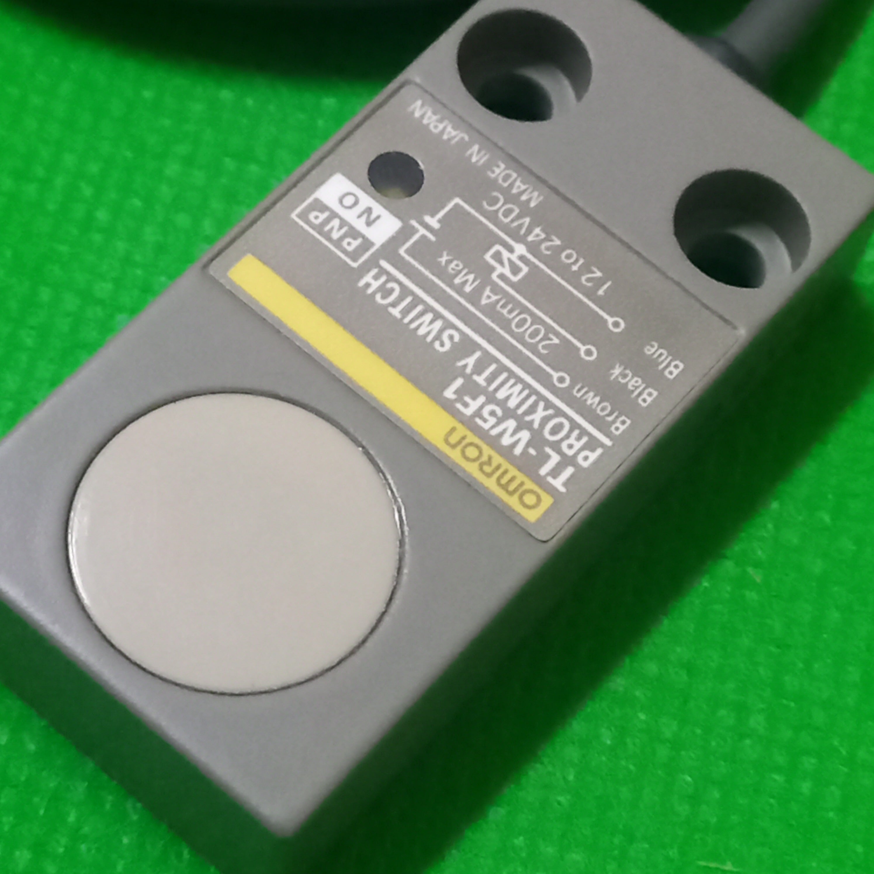 Specificaiton printed on the faceof TL-W5F1, Proximity Switch, PNP, NO, 12-24Vdc, made in Japan. 